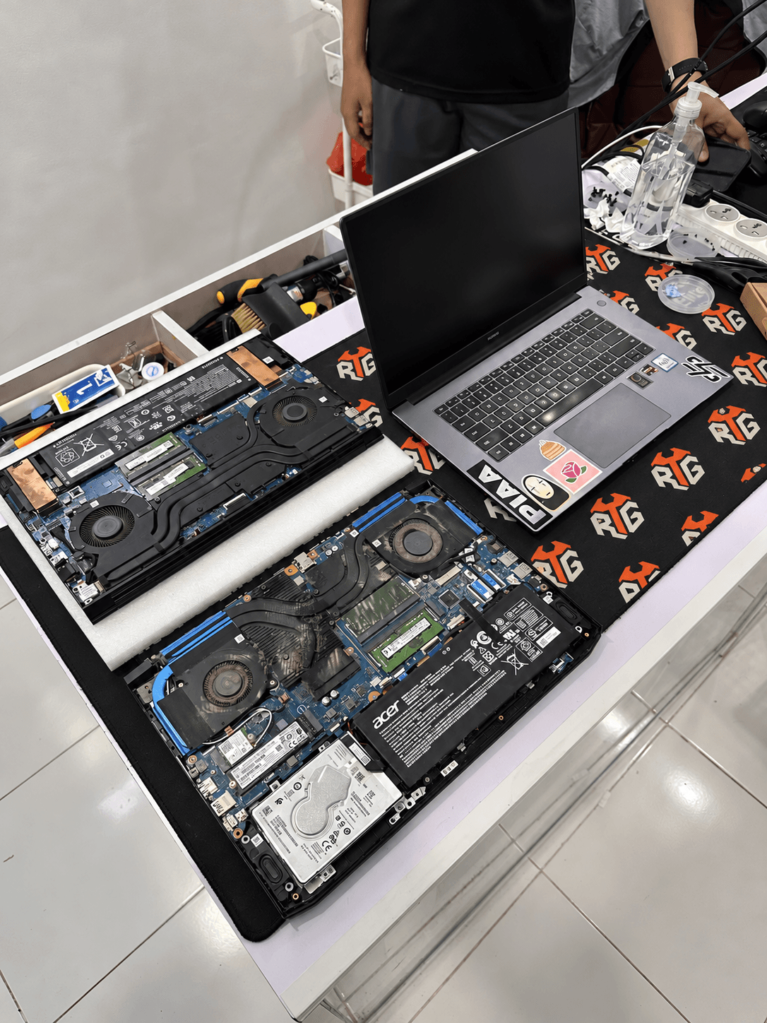 Laptop opened for repair on an RTG-branded workbench
