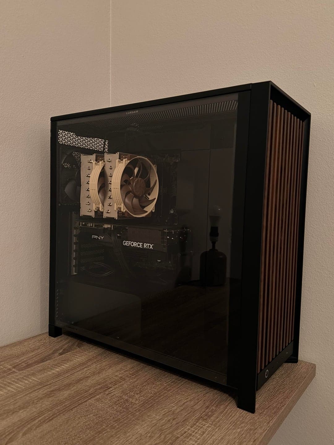 Angled view of the black client PC on a wooden desk